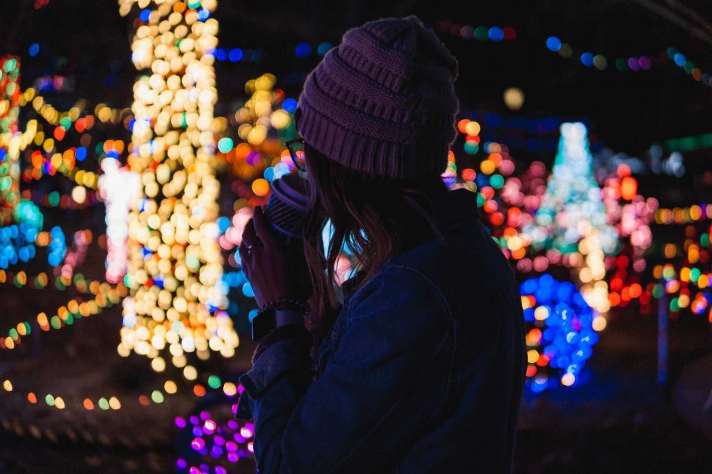 woman in front of holiday lights