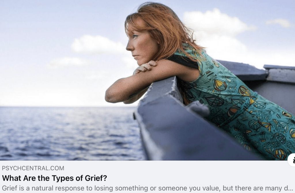 A woman sitting on a boat. This is a Psych Central article on the various types of grief.